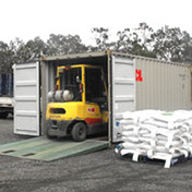 Shipping container being loaded by a forklift at Frances Seeds