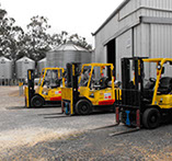 three forklifts